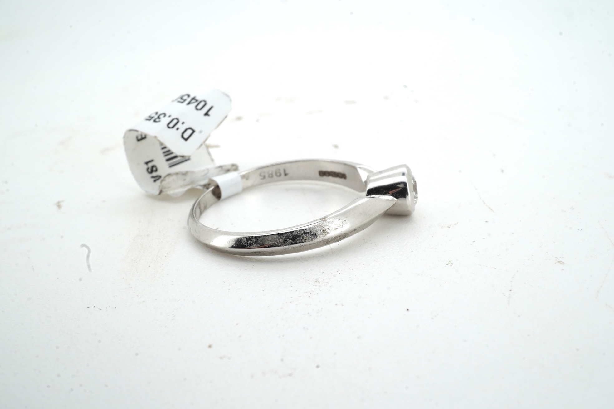 A diamond ring, collet-set with a brilliant-cut diamond weighing approximately 0.35 carats, mounted in 18ct white gold, size M, British hallmarks, gross weight approximately 2 grams